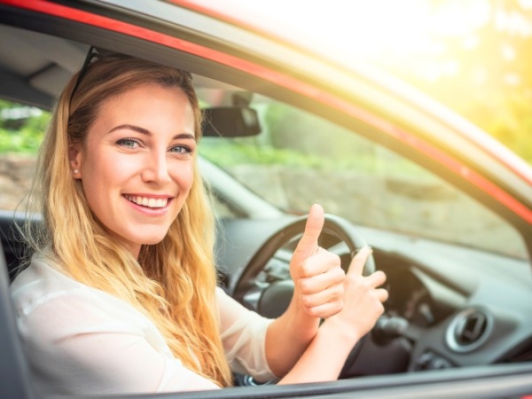 Woman Driving a Red Car