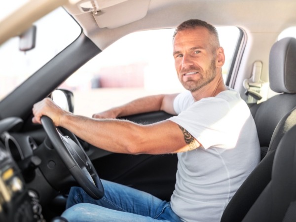 Man Driving a White Car