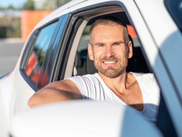 Man Driving a White Car