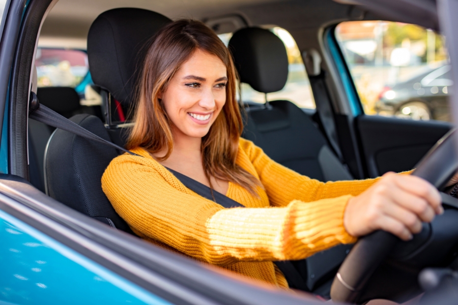 Woman Driving a Blue Car