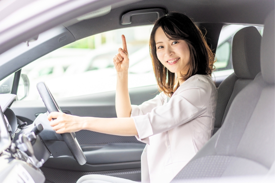 Woman Driving a Silver Car
