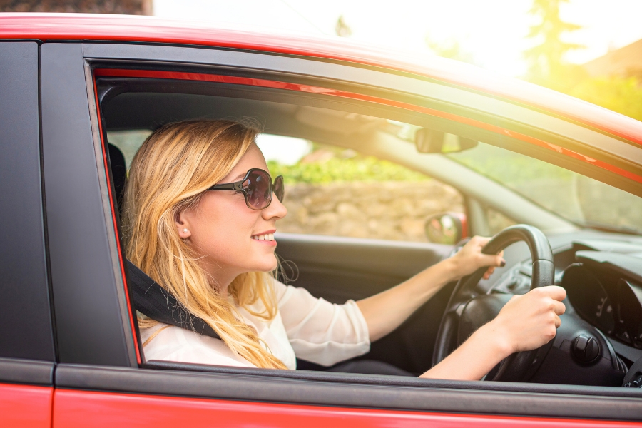 Woman Driving a Red Car