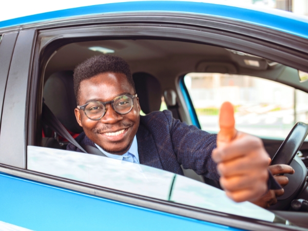 Man Driving a Blue Car