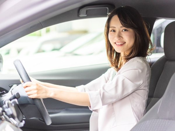 Woman Driving a Silver Car
