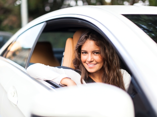 Woman Driving a White Car