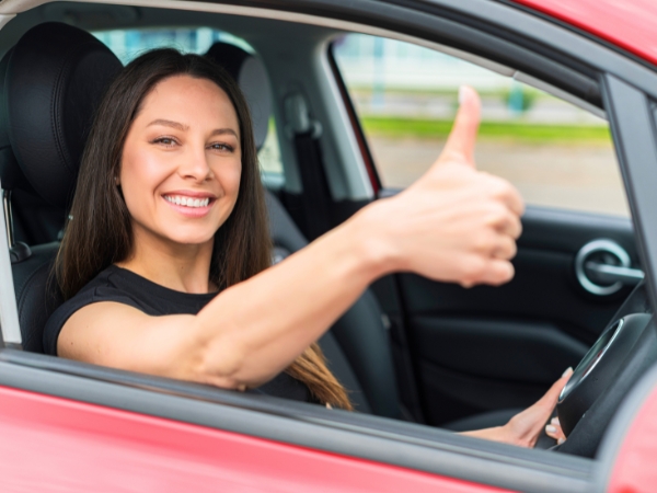 Woman Driving a Red Car