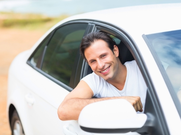 Man Driving a White Car